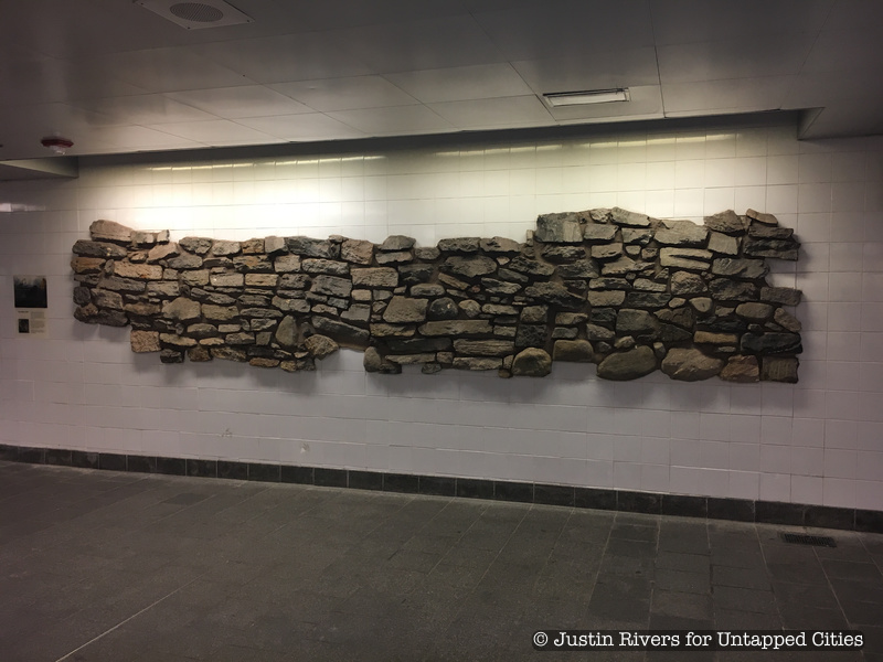 A colonial nyc stone wall in South Street subway station
