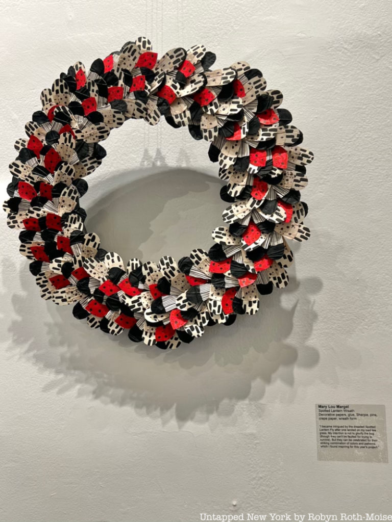 A wreath made out of origami lantern flies, part of the Wreath Interpretations exhibit, a unique holiday decorations display