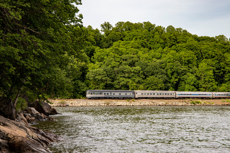 20th Century Limited train viewed from a distance set against lush green trees