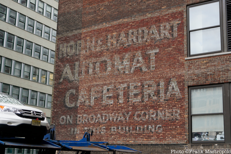 A painted ghost sign advertising Horn and Hardart automat on the side of a brick building
