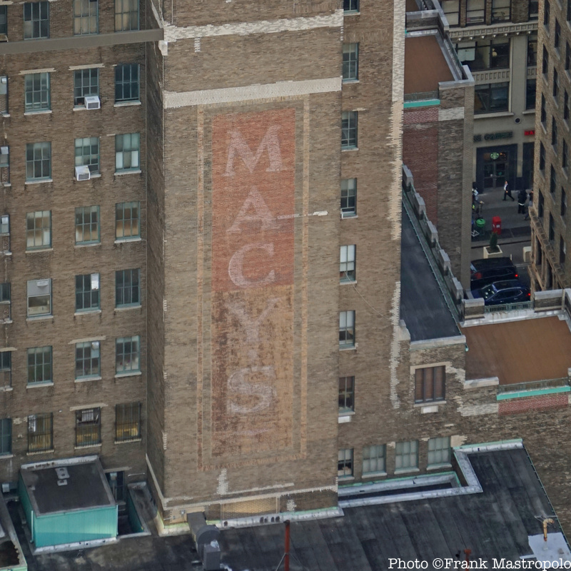 A Macy's ghost sign as seen from above on the side of a brick building
