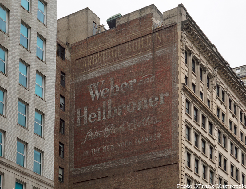 A painted ad ghost sign for Weber and Heilbroner on a brick wall