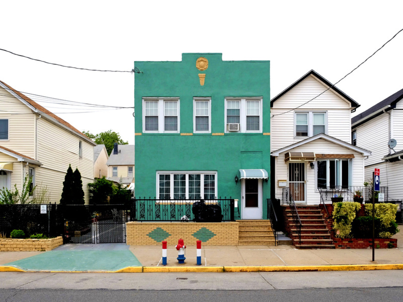 A vibrant green house in Queens