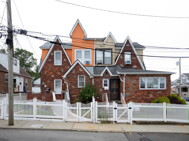 A brick facade house in Queens with many gables