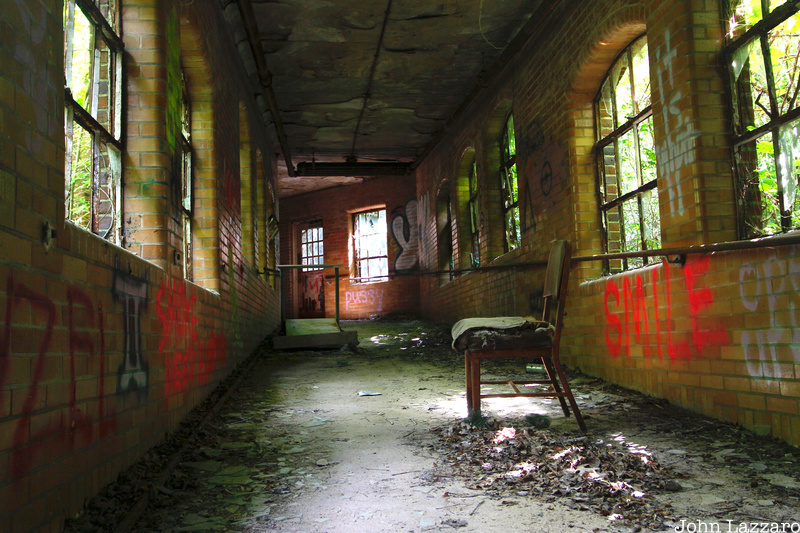 A window lined hallway with a chair at Kings Park Psychiatric