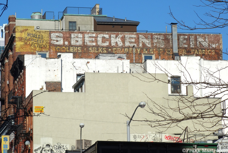 Side view of S. Beckenstein fabric store ghost sign, 130 Orchard Street on the Lower East Side. This sign is now obscured by new construction.