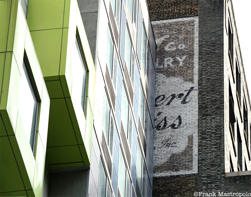 A ghost sign for Albert Weiss Jewelers is obscured by a newer building in the Garment District.