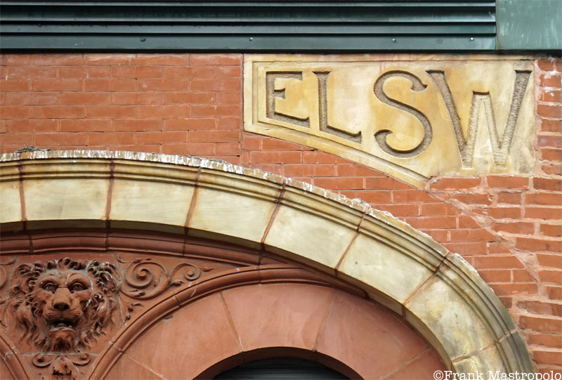 A puzzling ghost sign on a building in Hell's Kitchen reads "ELSW." It is on the Elsworth Building, which was cut in half for new construction.