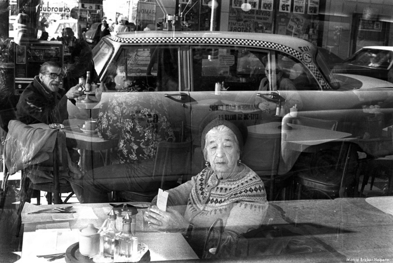 Woman sitting in the window at Dubrow's Cafeteria