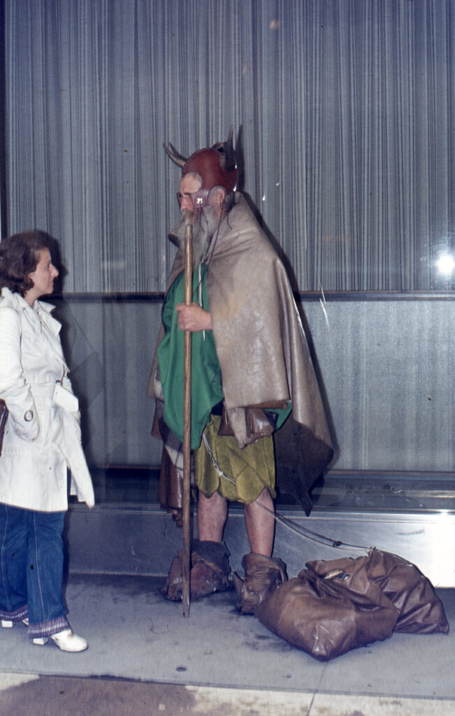 Moondog standing next to a woman on the street