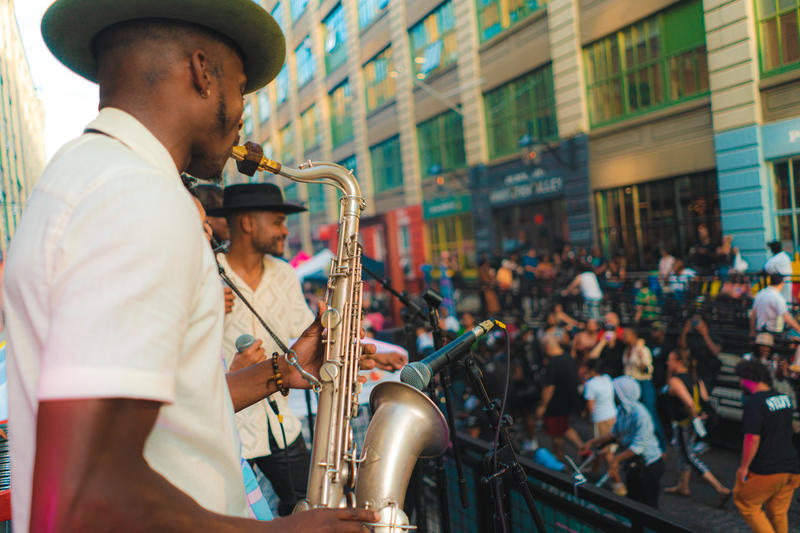Performers play saxophones to a crowd at the Brooklyn Night Market at Industry City