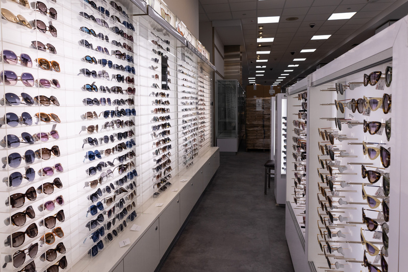 Rows of sunglasses on display in a store