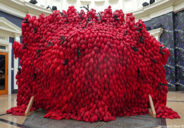 A sculpture at the New York Botanical Garden summer exhibit made of red gloves
