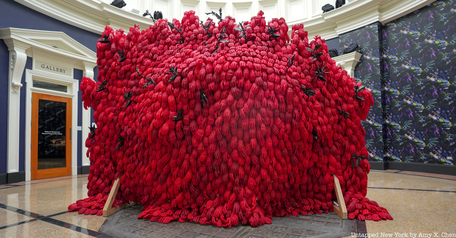 A sculpture at the New York Botanical Garden summer exhibit made of red gloves