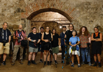 Group of photographers in an underground brick beer vault