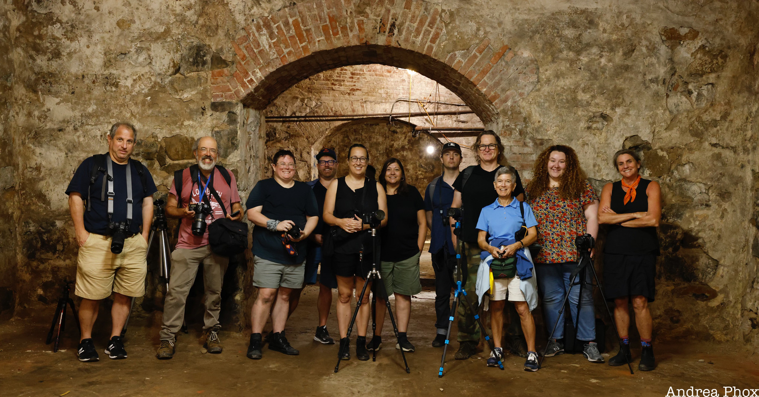 Group of photographers in an underground brick beer vault