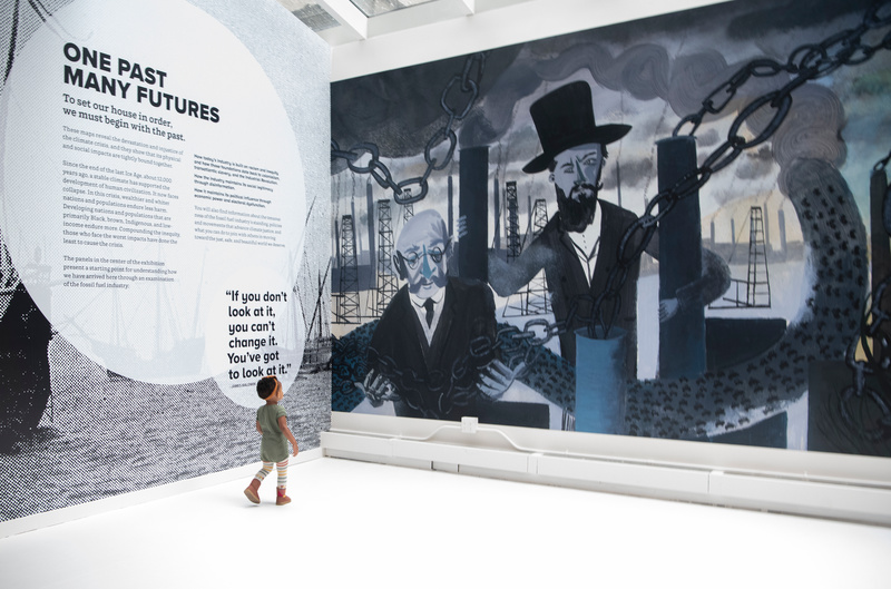 A child walks around an exhibit at The Climate Museum in NYC