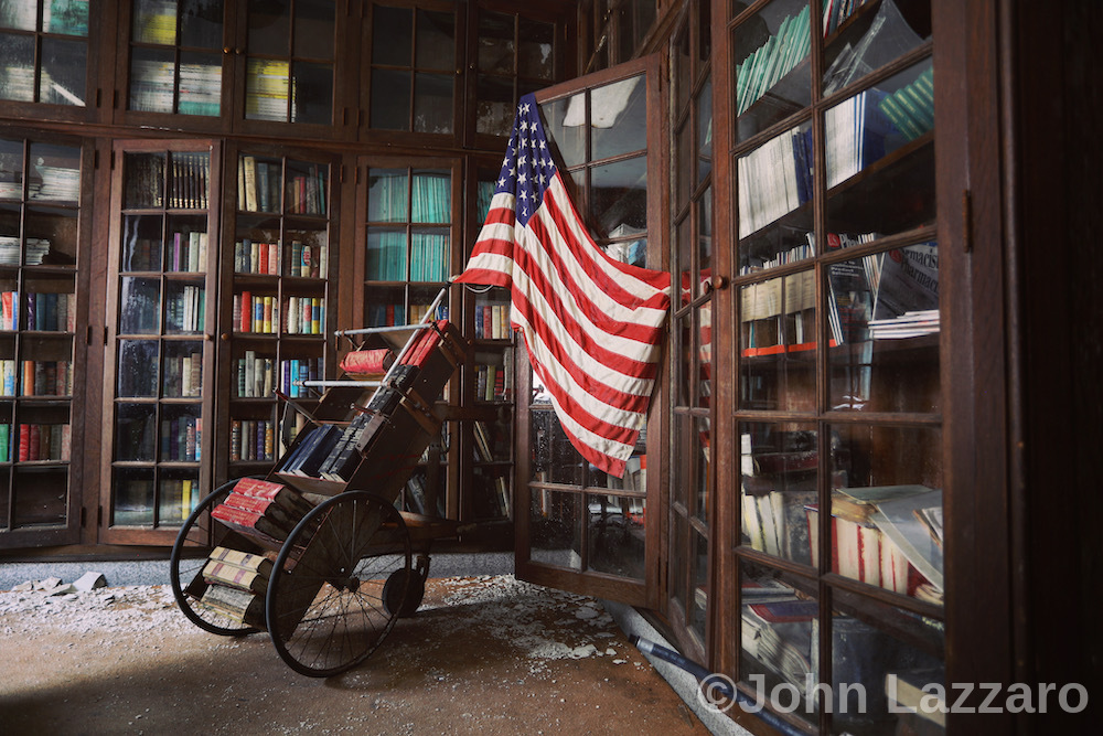 Wheelchair with an American flag in a room full of bookshelves