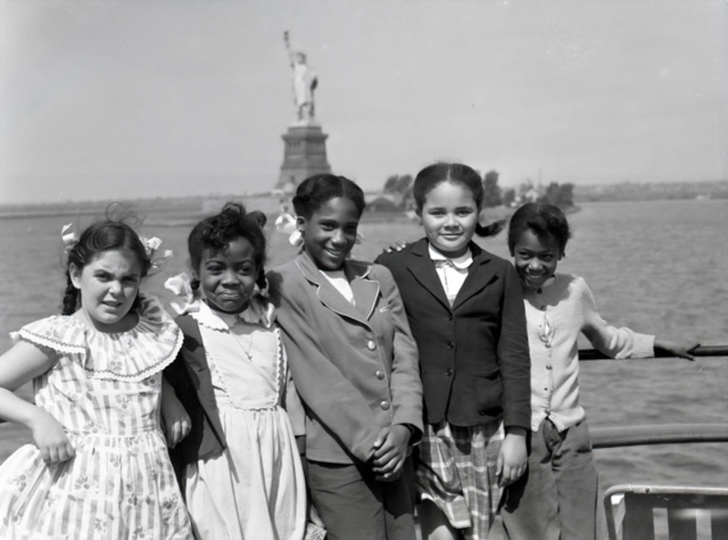 Kids in front of the Statue of Liberty on the Floating Hospital