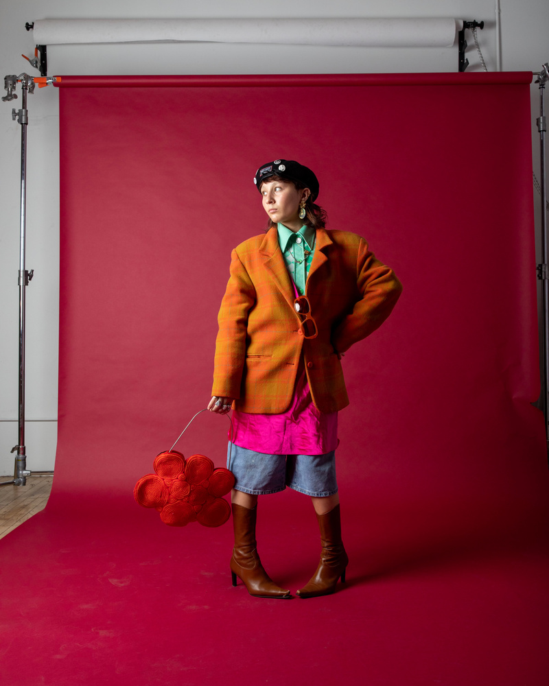 Rachel Waxenberg in a studio with a pink background illustrating Bushwick fashion