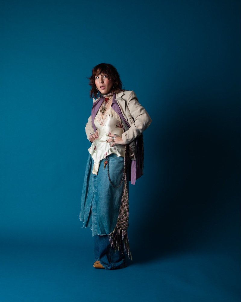 Rachel Waxenberg in a studio with a blue background illustrating Bushwick fashion
