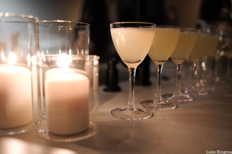 Row of Bees Knees cocktails and candles at The Lit Salon