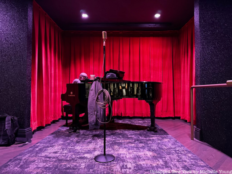 Piano against a red curtain