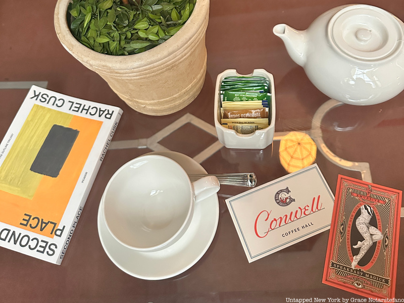 Teapot, tea cup and book on a table