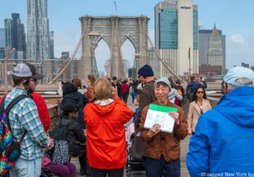 Group of tourgoers on the Brooklyn Bridge